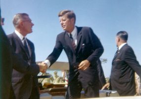 White men in suits shaking hands