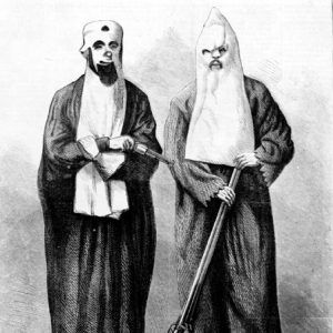 Two white men wearing masks and robes with guns