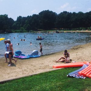 people on beach by a lake