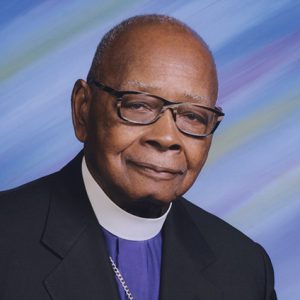 Older African-American man with glasses in suit and white collar