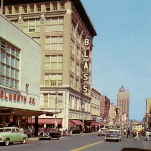 City street with tall buildings and parked cars