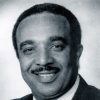 African-American man with mustache in suit and tie