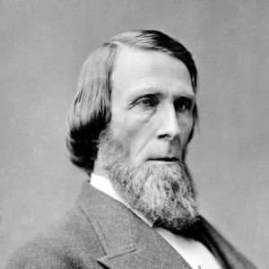 white man with beard in suit