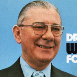 Poltical ad "Draft Wilbur Mills for President" with portrait of white man in suit and glasses.