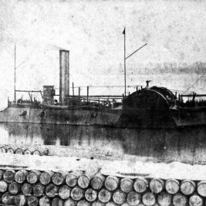 Large iron boat with chimneys flagpoles and sailors viewed across wall of floating barrels.