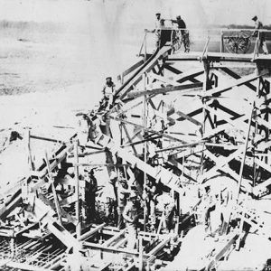 Workers building a dam on river