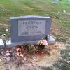 "Robert McCollum" grave marker in cemetery with beer can and flowers on his grave