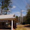 Building labeled "Education Center" with covered drive through entrance and oil derrick