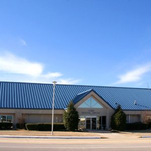 building with metal roof with sign "Ozark Regional Airport"