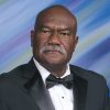 African-American man with mustache in tuxedo