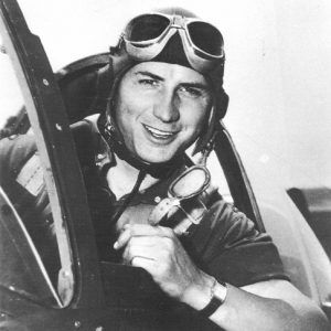 Young white man with goggles in an airplane