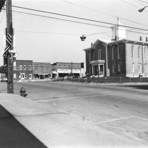 City square with power lines and brick courthouse in center