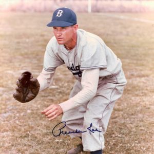 White man crouching with glove in baseball uniform and cap signed "Preacher Roe"