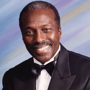 African-American man with mustache in tuxedo