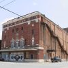 multistory brick building with stairs exterior stairs leading to top floor