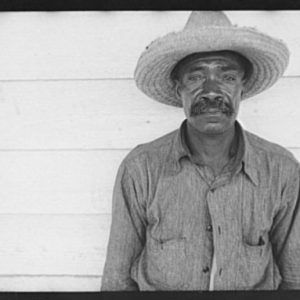 African-American man with mustache in straw hat