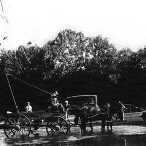 horse-drawn buggy operating via ropes and pullies a ferry with car