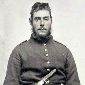 White man with mustache and beard in military uniform with long knife