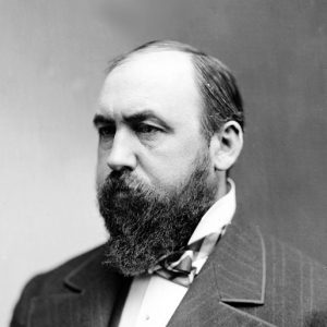 Portrait stern middle aged balding white man long beard mustache suit bow tie