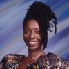 African-American woman smiling in multicolored dress