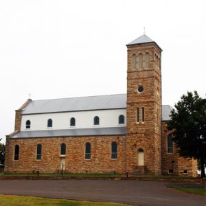 two-story brick church with bell tower