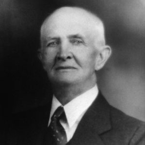 Bald white man in suit and tie