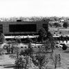 multistory building with parking lot and grounds with trees