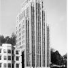 Tall office building with four-story building beside it