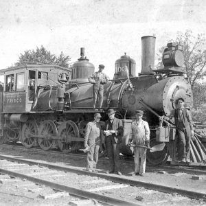 White men posing with a steam locomotive "Frisco"