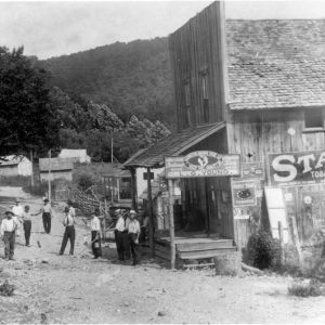 Group of men with digging tools outside the "L. G Young" store