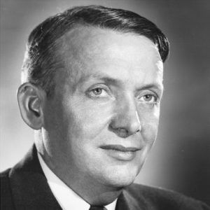 White man in suit with floral tie