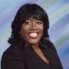 African-American woman smiling in black top