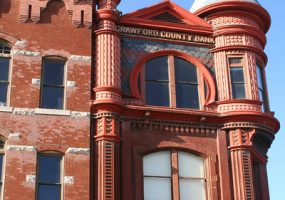 three-story Victorian style building with words at top reading "Crawford County Bank"