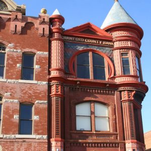 three-story Victorian style building with words at top reading "Crawford County Bank"