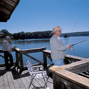 two white men fishing off a dock