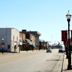 street with businesses and street lamps along either side