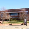 brick and glass building "Walton Arts Center."