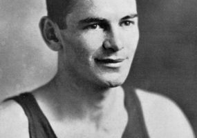 Young white man smiling in dark tank top