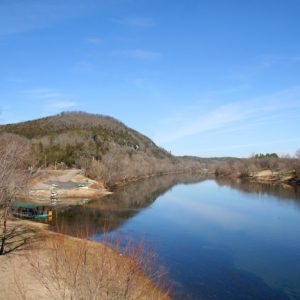 tree covered hill and river and dock and parking lot