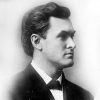 Profile view of white man in suit and tie