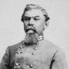 White man with beard in gray military uniform