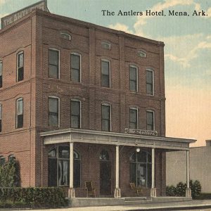 Three story red brick building with covered entrance