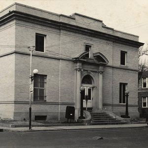 Pale brick building with arched entrance