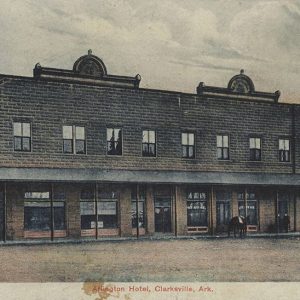 Long two story brick building with covered sidewalk