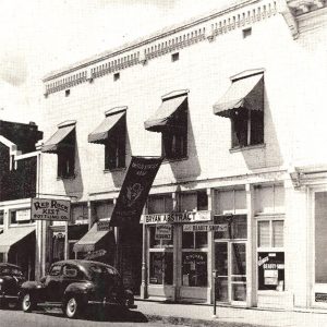 Two story white office building with multiple awnings