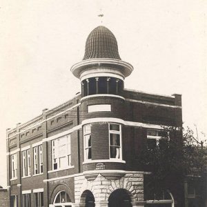 Multistory brick building with stone entrance and large cupola