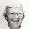 Portrait of white man with glasses in white shirt