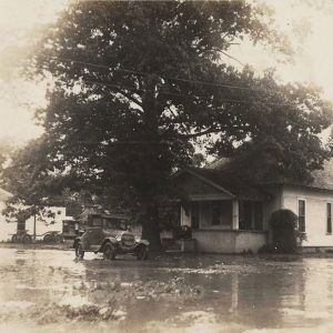 Car and house in flood waters