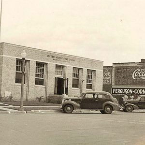 Single story brick building with cars parked out front