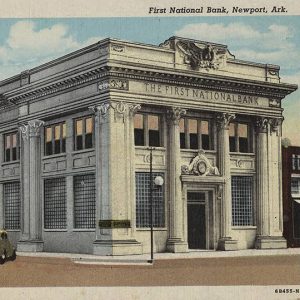 Multistory marble building with cars parked in front